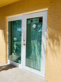 Image of a glass door installation on Aeroseal Commercial Windows and Storefront's website.