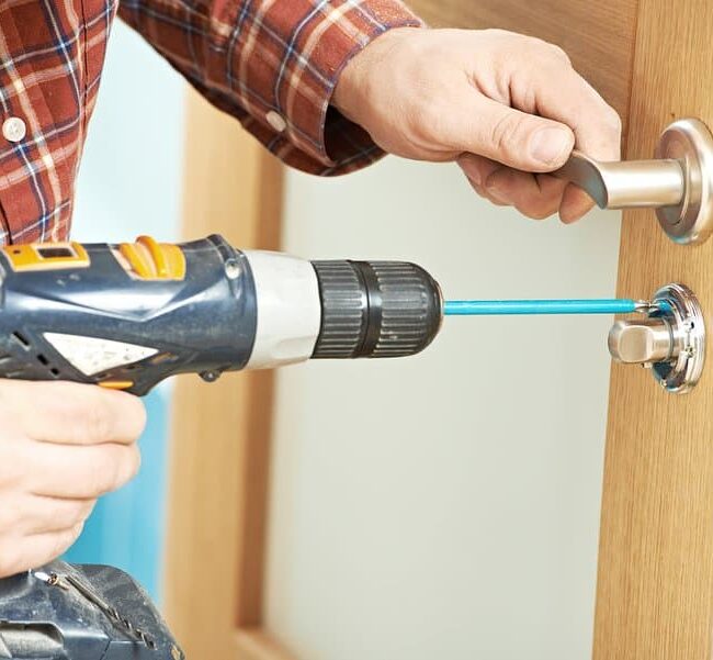 Image of a carpenter installing a door lock on Aeroseal's website