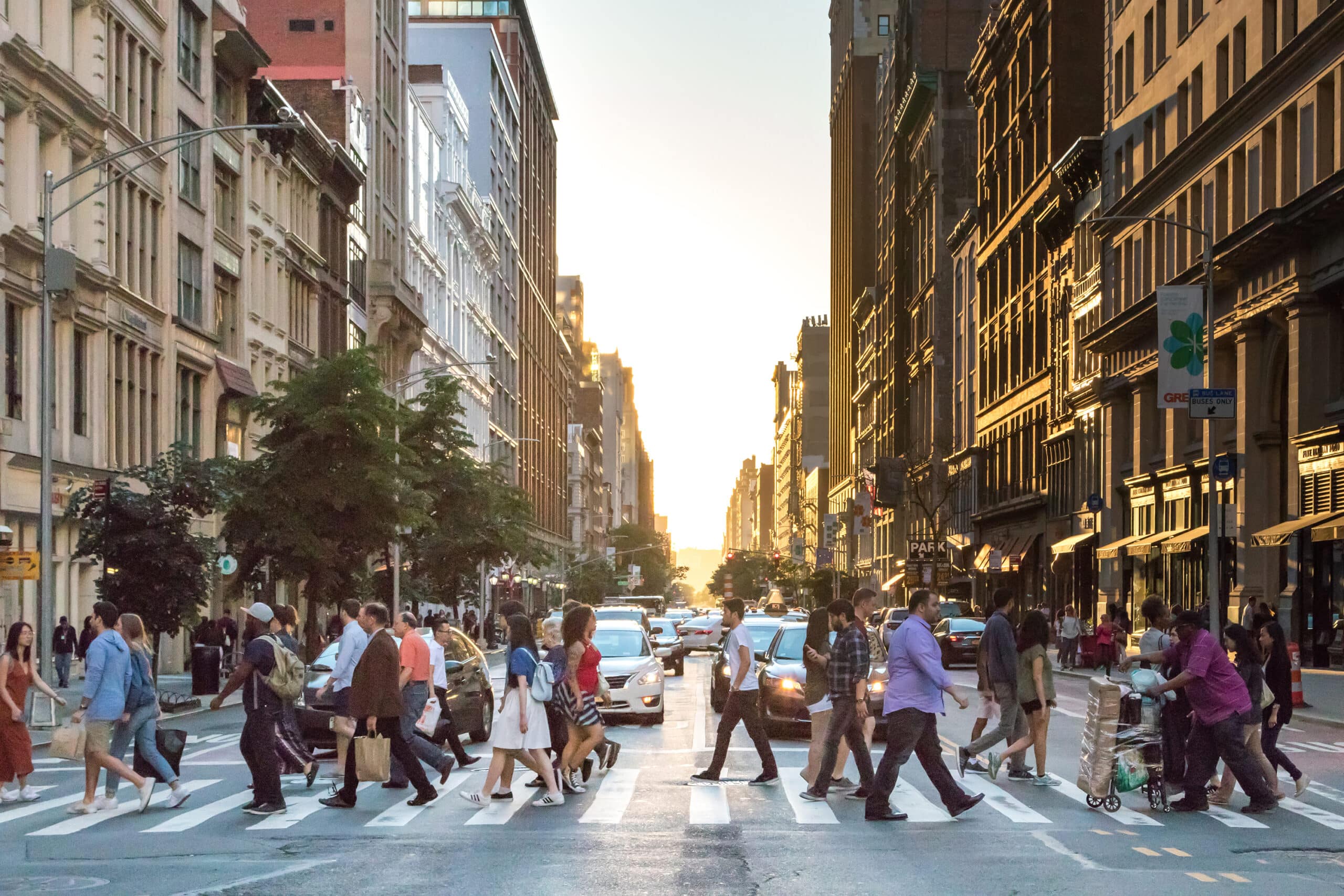 Image of a crowd of people walking on a crosswalk in Manhattan