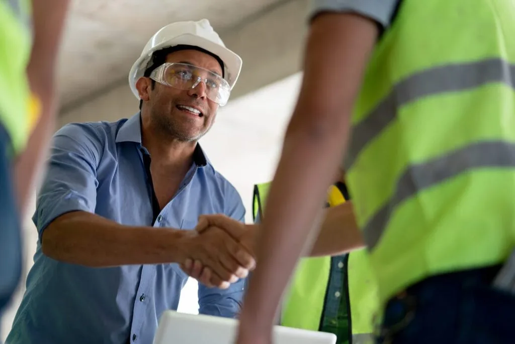 Image of workers shaking hands at a jobsite